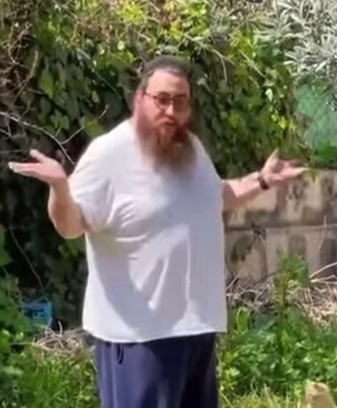 Yakob, the house stealer, shrugging with a confused look on his face.