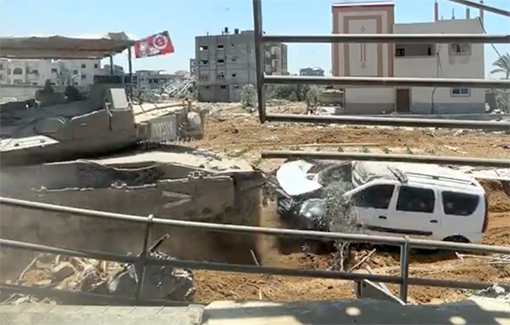 Thumbnail preview image for the video titled: An Israeli soldier posts a video from Rafah of a Merkava tank smashing into a minivan with the headline: “POV: You are playing GTA in Rafah”