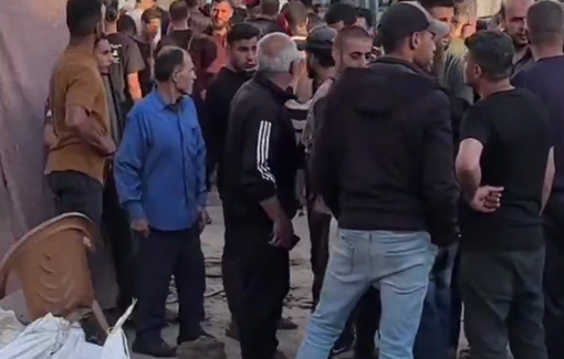 Thumbnail preview image for the video titled: Civilians inspect the destruction by Israeli bombing of tents at Abu Hamisa school