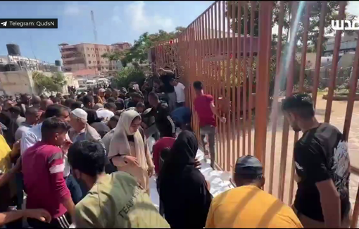 Thumbnail preview image for the video titled: Families mourn more than a dozen Palestinians killed in their tents at Al-Hinnawi school