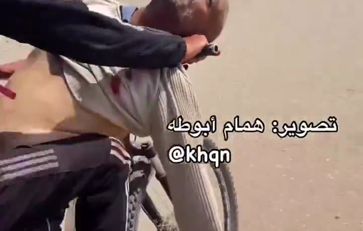 Thumbnail preview image for the video titled: A son transports his father's body on a bicycle after he killed at US/Israeli aid sites in Rafah