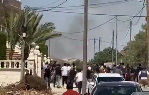 Thumbnail preview image for the video titled: Dozens of armed Israeli settlers attacked the village of Turmusayya, setting Palestinian homes and fields on fire