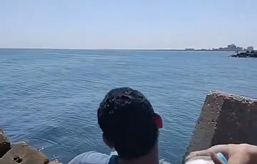Thumbnail preview image for the video titled: Egyptian throws plastic bottles filled with food/aid into the sea, hoping they reach Gaza
