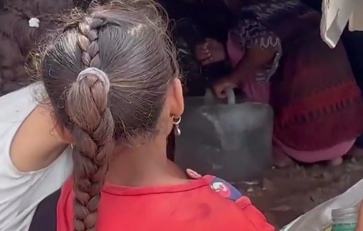 Thumbnail preview image for the video titled: Barefoot children get under a truck to collect leaking water