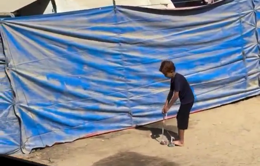 Thumbnail preview image for the video titled: A child fashions protection for his feet out of tin cans, instead of shoes