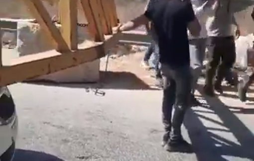 Thumbnail preview image for the video titled: The body of a deceased woman was transferred from one ambulance to another at the Salfit gate because of the Isreli checkpoint