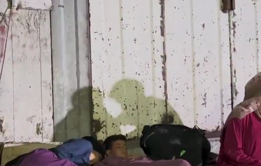 Thumbnail preview image for the video titled: Displaced family out on the street at night outside Al-Shifa hospital