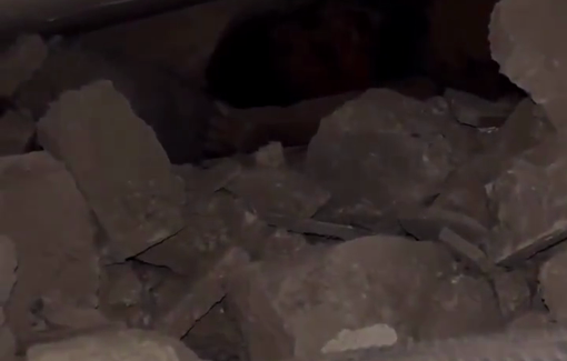 Thumbnail preview image for the video titled: First responder comforts crying child stuck under the rubble of her home bombed by Israel