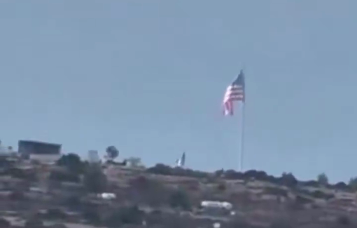 Thumbnail preview image for the video titled: Settlers raise the American flag atop Jabal al-Ras in the village of Umm Safa