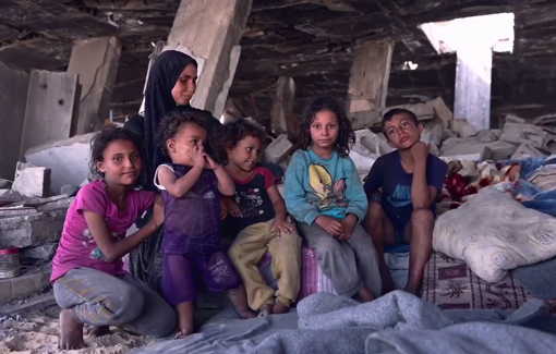 Thumbnail preview image for the video titled: Displaced family shelters in the ruins of a bombed building