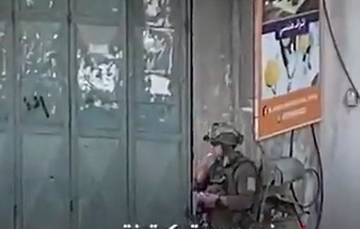 Thumbnail preview image for the video titled: A soldier steals a carton of "Ras El Abd" sweets and eats it during a raid on Beit Furik