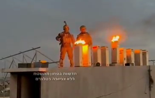 Thumbnail preview image for the video titled: Israeli soldiers celebrating the Hanukkah holiday by lighting torches atop the ruins of Gaza’s Indonesian Hospital