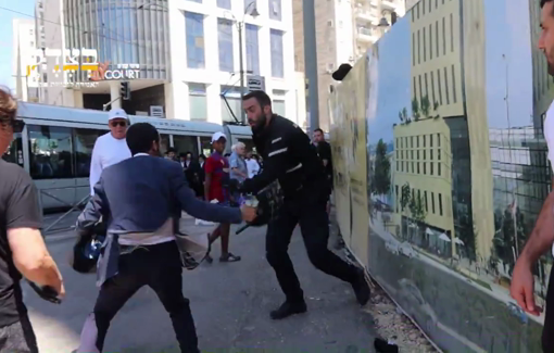 Thumbnail preview image for the video titled: A police officer violently assaults a Haredi demonstrator, using kicks, batons, and insults