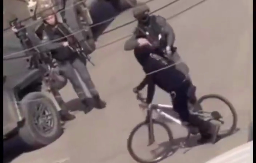 Thumbnail preview image for the video titled: An Israeli soldier violently pushes a child on a bicycle and injures him during a raid in Qalqilya
