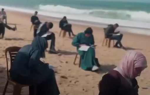 Thumbnail preview image for the video titled: Students in Gaza sit exams by the sea after their schools and universities were destroyed during the ongoing genocide